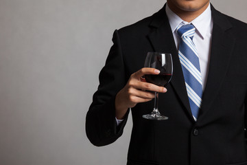 Asian businessman body with glass of red wine