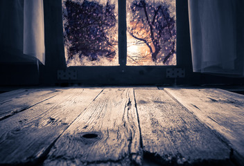 Old rural interior window table overlooking winter evening