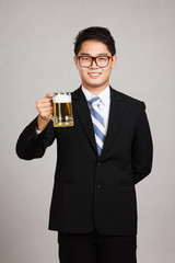 Asian businessman with mug of beer