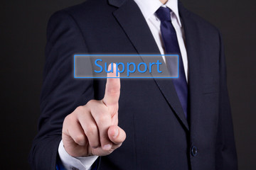 businessman pressing support button over dark background