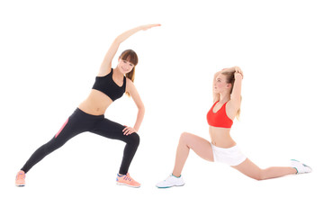 Obraz na płótnie Canvas two slim sporty women doing stretching exercises isolated on whi