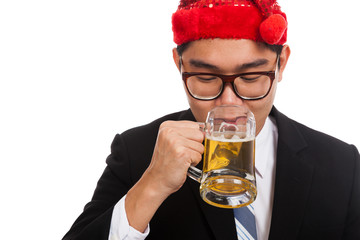 Asian businessman with red christmas hat drink beer