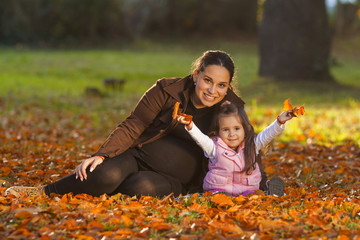 Young girl with her mother in autumn color