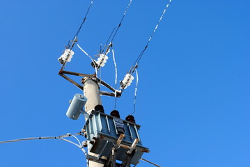 utility pole with electric frozen wires and cables