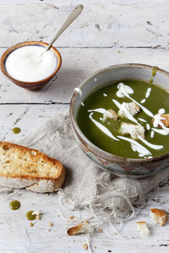 peas and spinach cream soup with sour cream and bread croutons