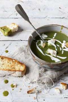 peas and spinach cream soup with sour cream and bread croutons