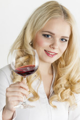 portrait of young woman with a glass of red wine