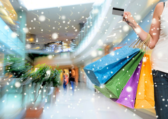 Woman holding shopping bags and credit card