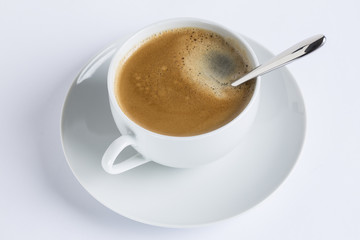Cup of coffee on a white plate on white background
