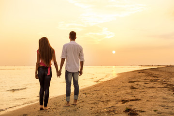 Beautiful Couple walking on beach