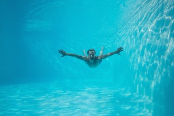 Young man swimming underwater