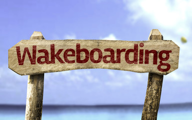 Wakeboarding sign with a beach on background