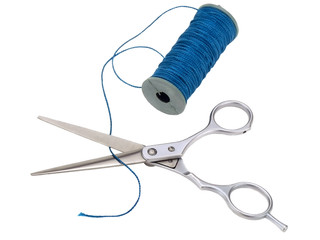 ..scissors and a spool of blue thread on white background