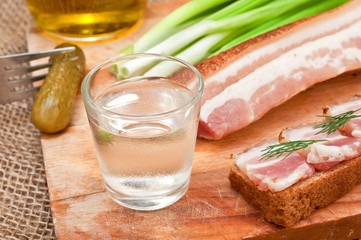 glass of vodka, cucumber and bacon