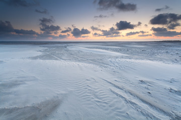 Fototapeta na wymiar sunrise over sand beach on North sea