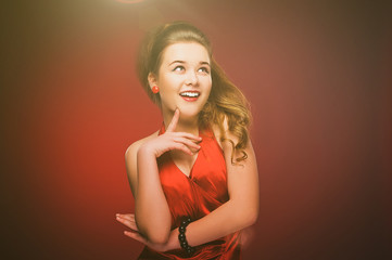 Stylized retro portrait of a young woman in red dress.