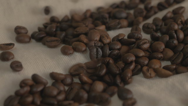 Roasted coffee beans. Falling coffee beans