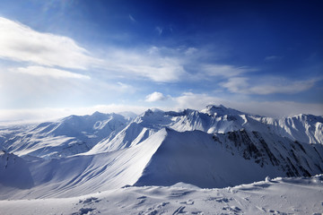 Obraz na płótnie Canvas Snowy mountains and sunlight sky