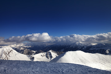 Off-piste slope and beautiful snowy mountains in evening