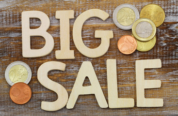 Big sale written with wooden letters and Euro coins