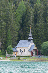 Fototapeta na wymiar Small church on the shore of lake Braies, Dolomites, Italy