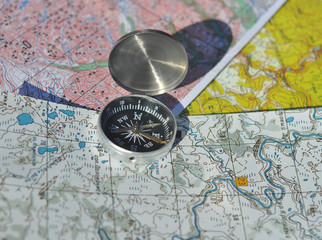 Fototapeta na wymiar Compass on the maps.