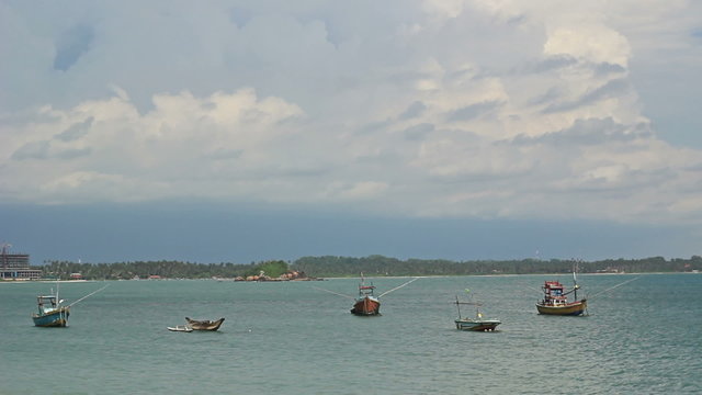 Small vessels are in a large bay in the ocean