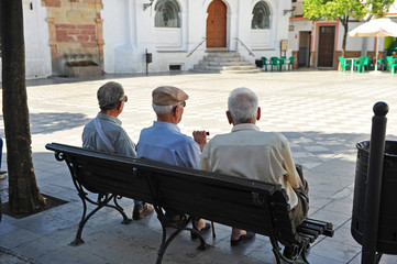 Three old men sitting on the bench, Spanish village