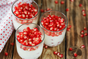 closeup Delicious dessert  pannacotta with fresh pomegranate see