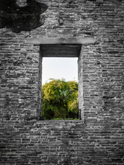 Black and white color of ancient  brick wall with a window view