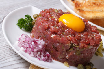tartare meat with egg, onion and capers closeup