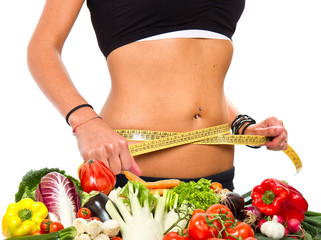 A slim girl measuring her waist