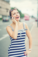 Beautiful woman talking on mobile phone in the city