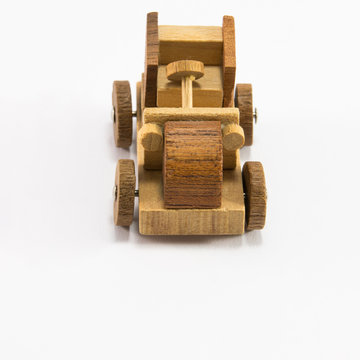 Wooden toy car miniature on white background