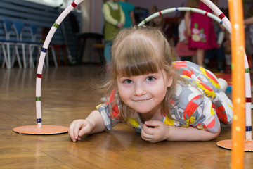 Beautiful girl takes part in relay competition in kindergarten