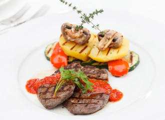 Grilled steak with baked vegetables