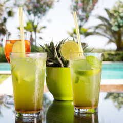 Two mojitoes with glass of Aperol Spritz at background