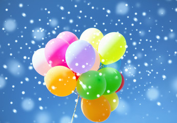 lots of colorful balloons in sky with snowflakes