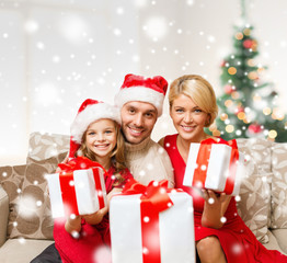 smiling family holding many gift boxes