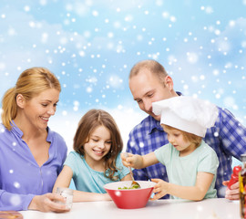 happy family with two kids making salad at home