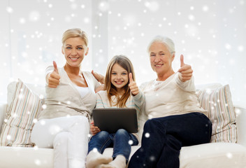 smiling family with tablet pc at home