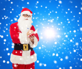 man in costume of santa claus with notepad