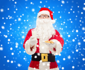 santa claus with glass of milk and cookies