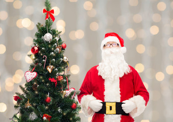 Fototapeta premium man in costume of santa claus with christmas tree