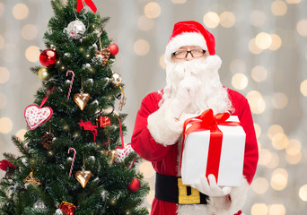 man in costume of santa claus with gift box