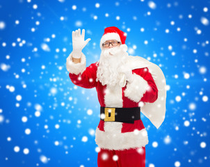 man in costume of santa claus with bag