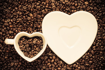 cup and saucer on coffee beans background