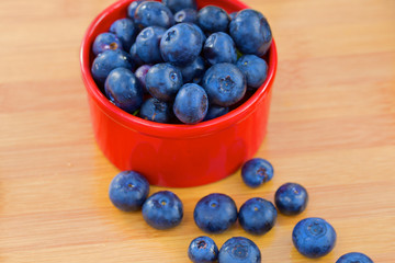 Blueberry in red can on a wooden table