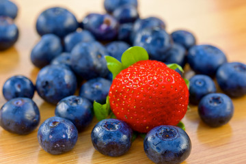 Bunch of bluberries and strawberry on a table
