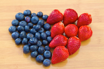 Heart made of blueberries and strawberries